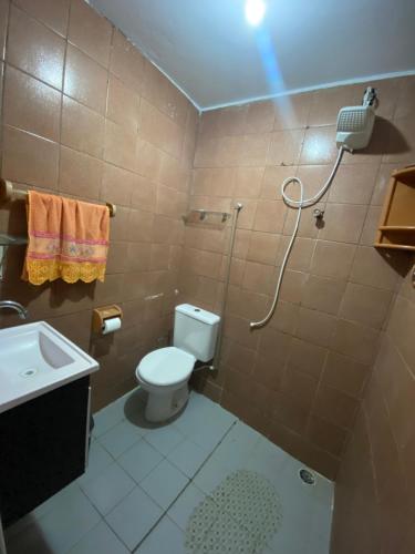 a bathroom with a shower and a toilet and a sink at Flat imobiliado feitosa in Maceió