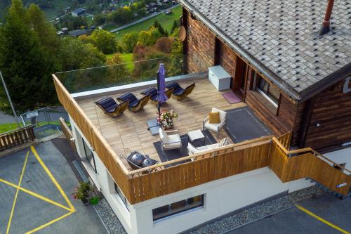 an overhead view of a deck with furniture on a house at Hotel Bellwald in Bellwald