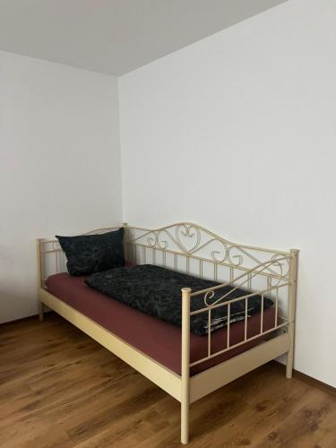 a bed with a metal frame in a room at AK Ferien-Monteurwohnung in Olpe