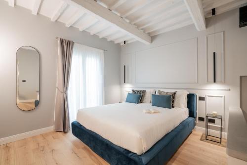 a bedroom with a large bed and a mirror at Maison Ginori Guelfa in Florence