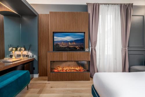 a hotel room with a bed and a fireplace at Maison Ginori Guelfa in Florence