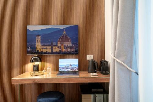 a desk with a laptop computer on top of it at Maison Ginori Guelfa in Florence