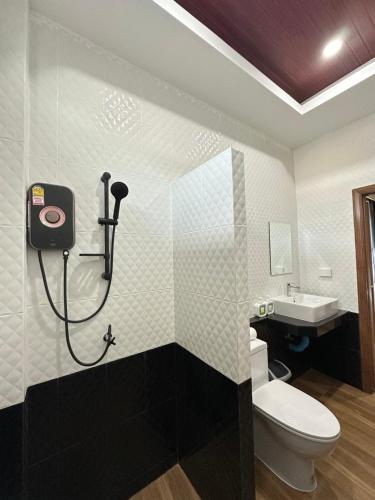 a bathroom with a shower and a toilet and a sink at Mega Pool Villa,Aonang in Ao Nam Mao
