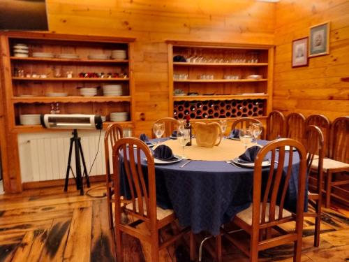a dining room with a table with chairs and wine bottles at Hotel Capellan in Navia