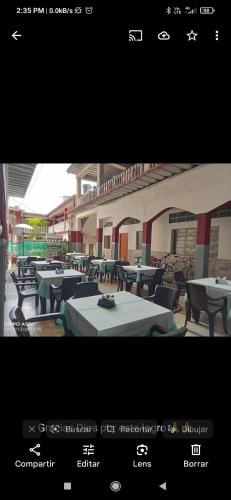 a picture of a restaurant with tables and chairs at Hotel los Mangostinos cl 7#5-26 in Mariquita