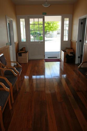 a living room with a wooden floor and a door at Abisko Lodge in Methven