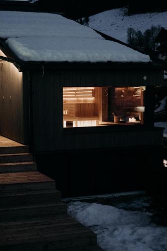 a building with a window with snow on top of it at kerii - adults boutique hotel in Saalbach Hinterglemm