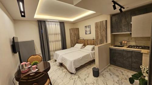 a hotel room with a bed and a kitchen at My Villa Hotel in Sheikh Zayed