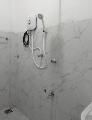 a bathroom with a shower with a phone on the wall at Villa kandupamula in Mirissa