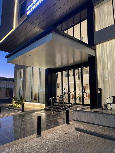 a large building with a person standing outside of it at Marvelous Hotel in Tabuk