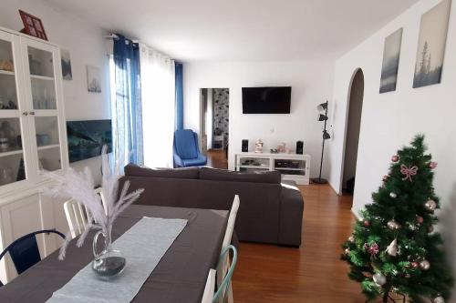 a living room with a christmas tree and a couch at Le Royal Condo, 13 P, WIFI & Parking à Disneyland in Chessy