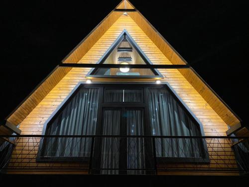 a house with a window with lights on it at Bajkoviti bungalov in Pale