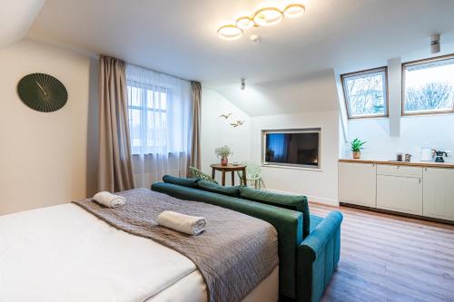 a bedroom with a large bed and a kitchen at Willa Lapwing in Sopot