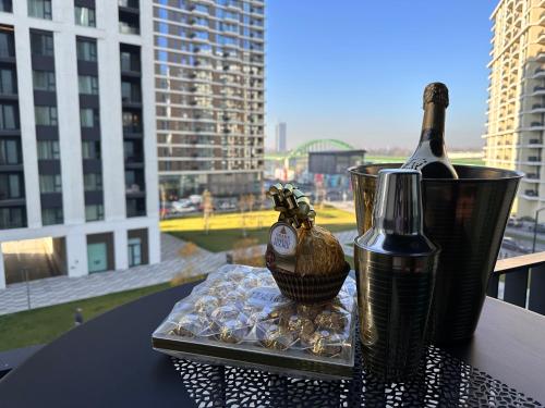 einen Tisch mit einer Flasche Wein und einem Glas in der Unterkunft SuprStay - Belgrade Waterfront Luxury Studio in Belgrad
