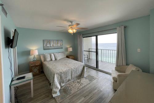a bedroom with a bed and a view of the ocean at Commodore 1305 in Panama City Beach