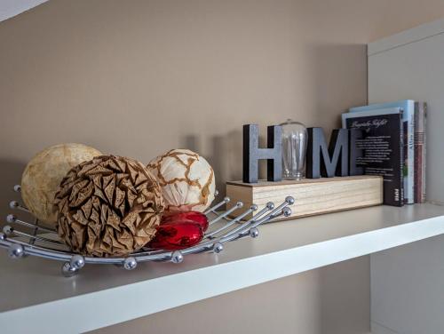 a shelf with three balls on it with books at Luxury Golf Apartment Bad Bellingen 5-9 in Bad Bellingen