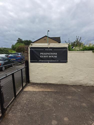 a sign on the side of a building at Pilkingtons Guest House Accrington in Accrington