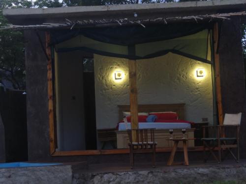 a bedroom with a bed in a tent at Doublegsafaris and camp mikumi in Mikumi