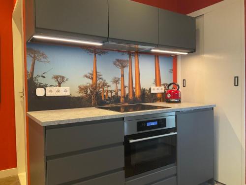 a kitchen with a sink and a stove at African Tree in Terwolde
