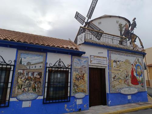 a blue building with mosaics on the side of it at Rincones de Darío: Capítulo II in Puerto Lápice