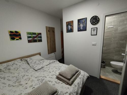 a bedroom with a bed and a bathroom with a sink at Apartmani Exit in Pale