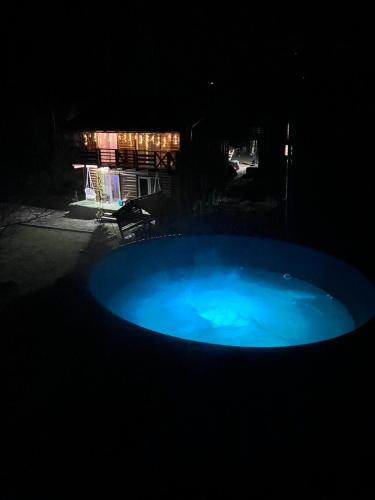 a large blue tub in a yard at night at Dva Braty eco in Podobovets