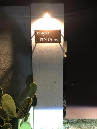 a sign for the entrance to a building with a plant at Dimora la Pinta ‘700 in Gallipoli