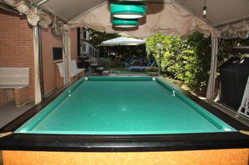 a pool table in a backyard with a tent at Verdon in Rome