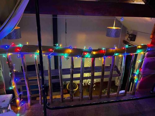 a railing with christmas lights on a balcony at Games Room in Llanfynydd