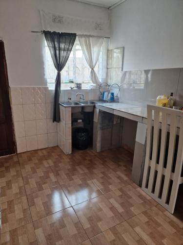 a kitchen with a sink and a counter top at Salama House in Lusaka