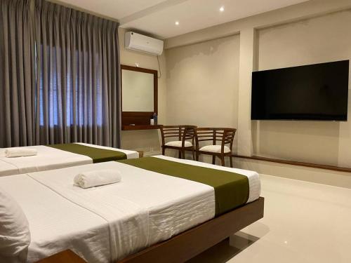 Postel nebo postele na pokoji v ubytování Lamandu City Hotel