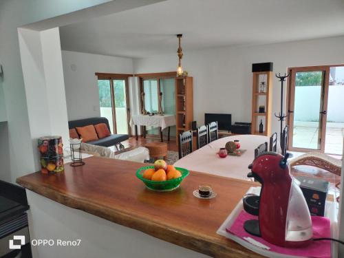 a kitchen with a table with a bowl of fruit on a counter at Residencial Monte Gordo Golf Rei Algarve in Monte Gordo
