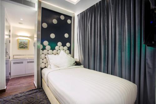 Łóżko lub łóżka w pokoju w obiekcie Grace 21 Smart Hotel