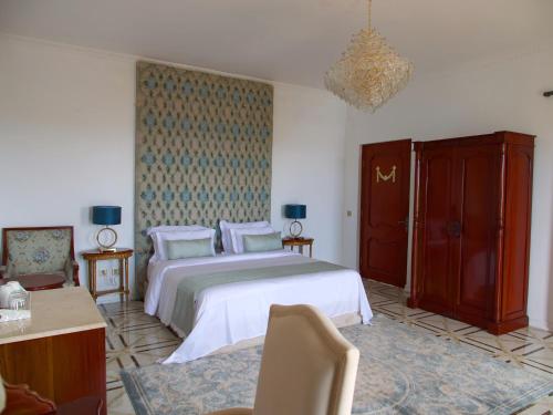 a bedroom with a large bed with white sheets and pillows at Jasmine Bay Hotel & Spa 