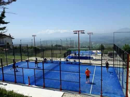 a group of people playing tennis on a tennis court at Agriturismo Alta Collina in Benevento