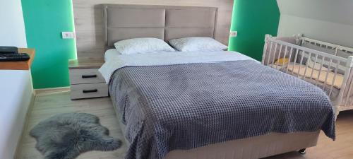 a bedroom with a bed with a gray blanket at Mountain inn in Žabljak