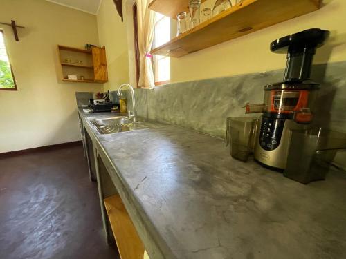 a kitchen with a counter with a coffee maker on it at Diana Place in Paje
