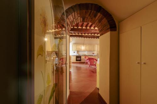 a hallway leading to a kitchen with an archway at Heart of Chianti - a warm flat in Radda in Radda in Chianti