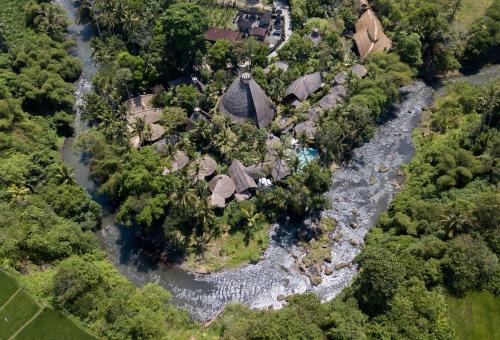 an aerial view of a river with houses and trees at Fivelements Retreat Bali, Ubud in Ubud