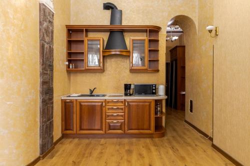 a kitchen with a sink and a stove at Апартаменти на Площі Ринок, 20 in Lviv