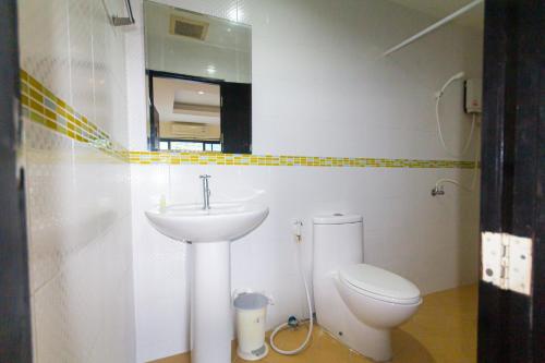 a bathroom with a white sink and a toilet at KRABI MORE HOTEL in Klong Muang Beach