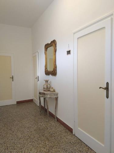 a white room with a table and a mirror at ORVIETO BRICK HOUSE in Orvieto Scalo