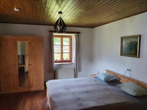 a bedroom with a large bed and a window at URige Hütte in Maria Elend