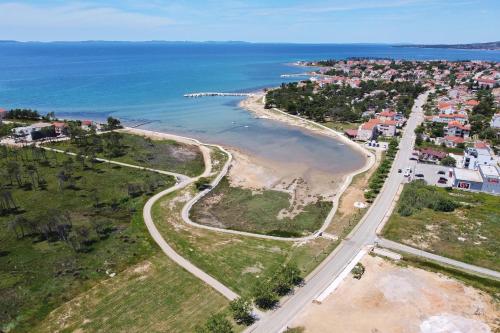 an aerial view of a beach and the ocean at Villa Stella with heated swimming pool in Privlaka