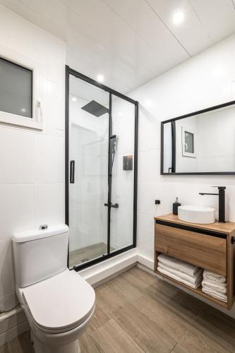 a bathroom with a toilet and a sink and a shower at Beach Apartment, next to the sea in Premiá de Mar