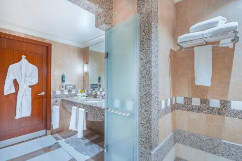a bathroom with a shower and a glass door at Madinah Hilton Hotel in Al Madinah