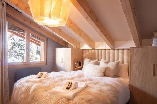 1 dormitorio con 1 cama grande y 2 toallas. en La Ruinette- Stylish 4-bed, Centre Of Verbier, en Verbier