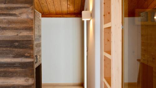 a room with a white wall and wooden walls at Du Parc Hotel in Sauze dʼOulx