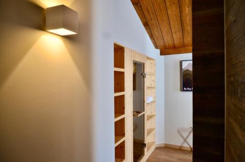 a room with a door and a light on the wall at Du Parc Hotel in Sauze dʼOulx