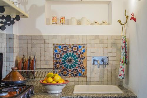 a kitchen with a bowl of fruit on a counter at Dar 91 Essaouira in Essaouira